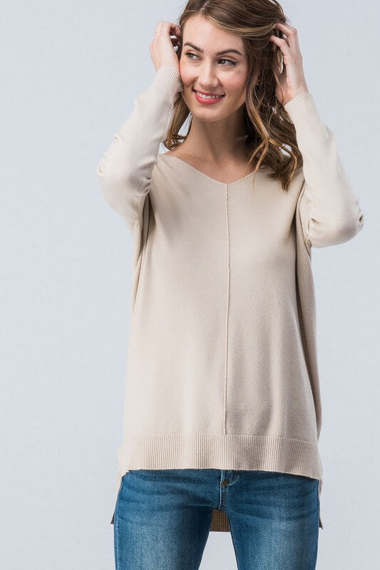 This sweater will quickly become one of your favorites! Soft high-low tunic sweater that can easily be dressed up or down. Thin enough to layer. 55% Cotton/ 45% Rayon. Super soft high-low sweater. Priced at $40.00.
