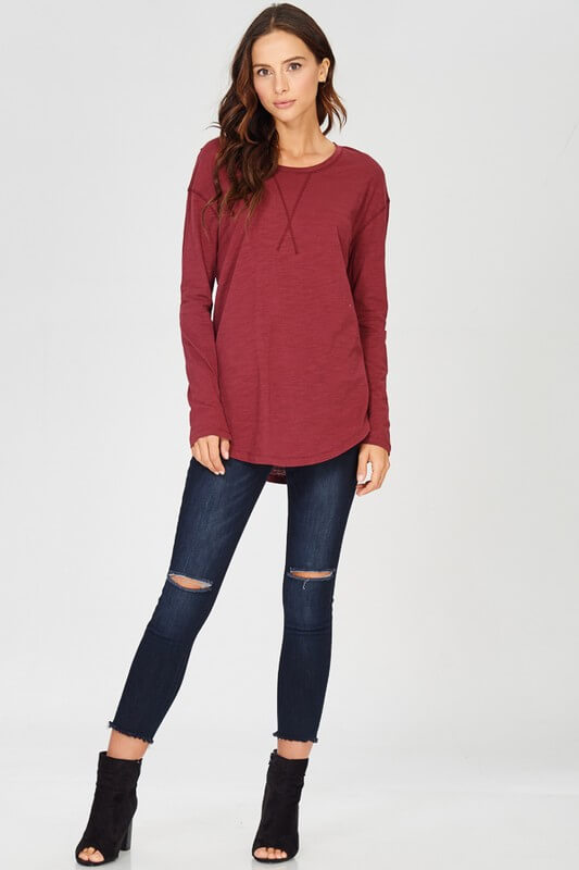 Another throw on and go long sleeve top that pairs with jeans or  layer under a sweater.  Slub jersey knit, x-stitched, crewneck, shirttail hem t -shirt.  100% Cotton. Available in wine and navy.  Priced at $32.00.